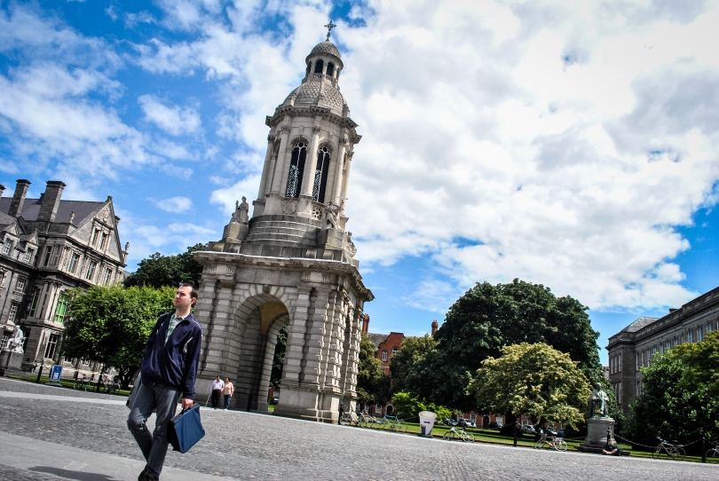 A man hurries past the Trinity College bell tower, one of the most distinguishing landmarks of the university.